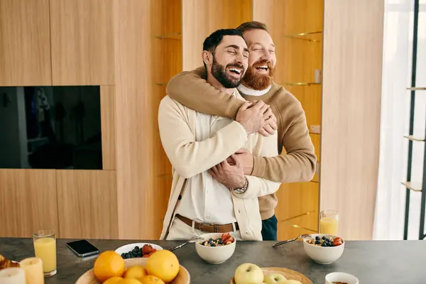 stock image Two men, a happy gay couple, hug lovingly in their modern kitchen, expressing their deep connection and joy in each others company.