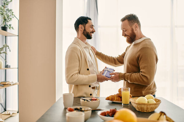 Two happy men exchange gift in a cozy kitchen, radiating love and joy as they share a special moment.