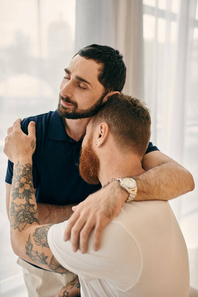 Two men in casual clothes share a warm hug in a modern living room, expressing love and togetherness.