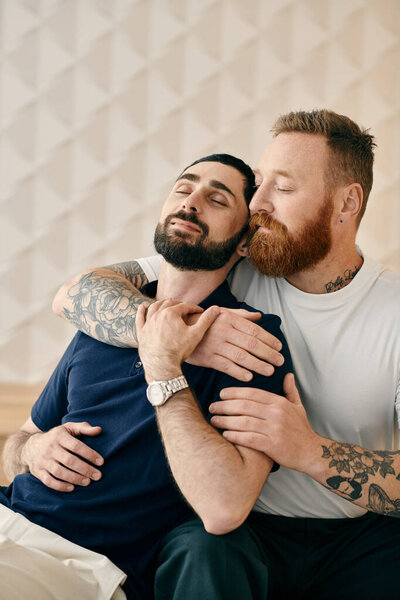 Two cheerful men dressed casually share a warm hug on a cozy bed in a modern setting.