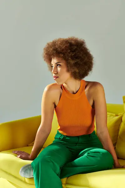 African American Woman Sits Gracefully Yellow Couch Embodying Serenity Vibrancy — Stock Photo, Image