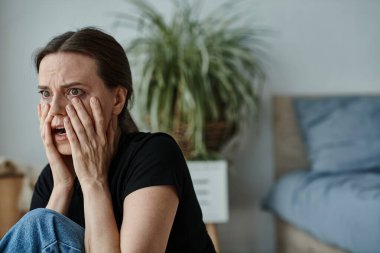Woman hides face in despair.