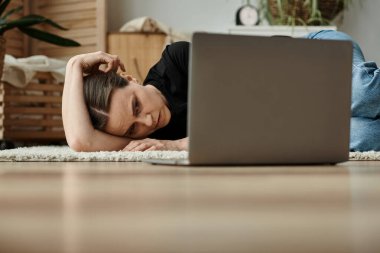 Woman finds comfort with her head on laptop, seeking solace from mental struggles. clipart