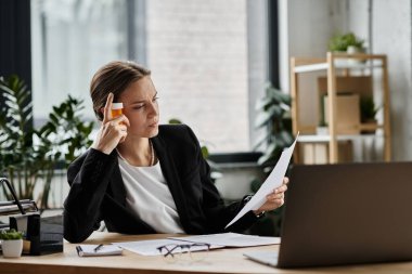 Middle-aged woman experiencing stress, analyzing a document at her office desk.