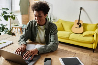 A young man focused on her laptop, working from home.