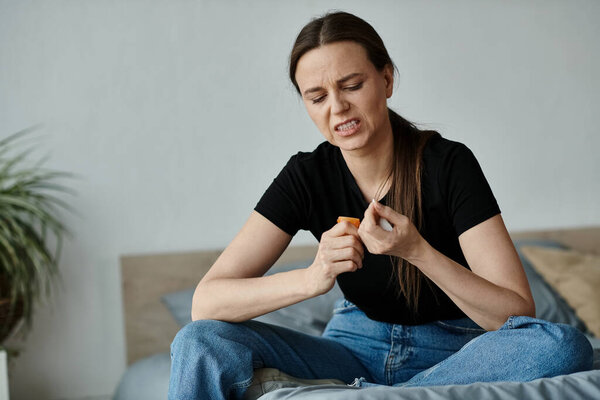 Middle-aged woman on bed, emotions evident.