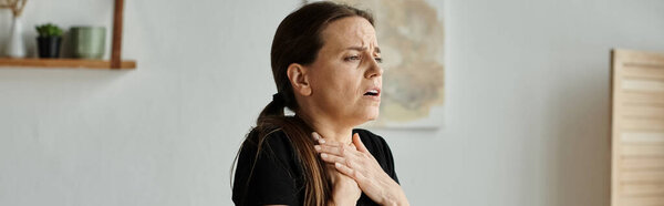 Middle-aged woman finding solace with hands on chest.
