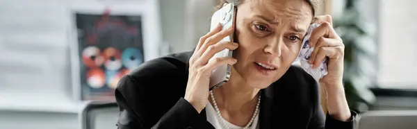stock image Woman in office, talking on phone at desk.