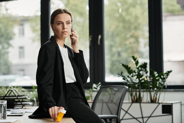 Businesswoman in office talking on phone, multitasking.