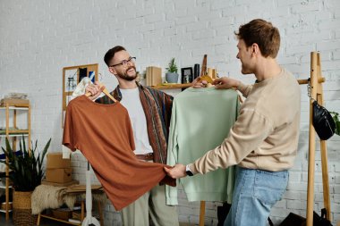 Two men in designer attire stand side by side, discussing ideas for their latest project in a trendy workshop. clipart