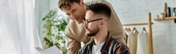 stock image A man sits on top of another, both supporting each other in a display of teamwork and trust.