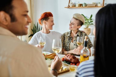 Diverse group enjoying dinner together at a table in a cozy setting. clipart