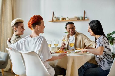 Çeşitli arkadaşlar yemek masasında şarabın tadını çıkarıyorlar..