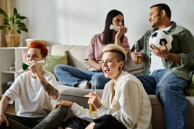 A group of people enjoying each others company on a couch. clipart