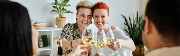 stock image A diverse group of women joyfully toast with wine glasses during a dinner gathering, with friends.