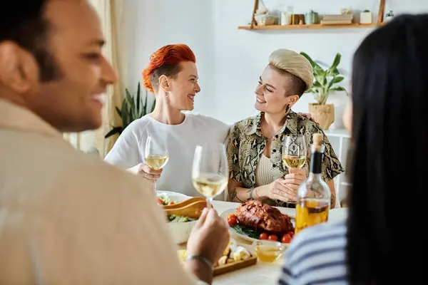 stock image Diverse group enjoying dinner together at a table in a cozy setting.