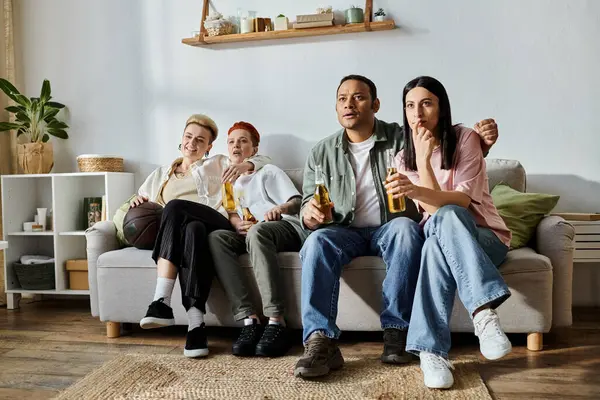 stock image A group of people, including a loving lesbian couple, sitting together on top of a couch.