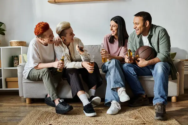 stock image A diverse group of people, including a loving lesbian couple, relaxing together on top of a couch.