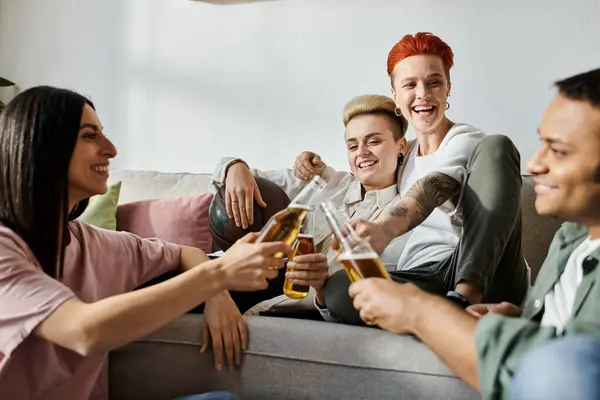 stock image Diverse friends and a loving lesbian couple lounging on a couch.