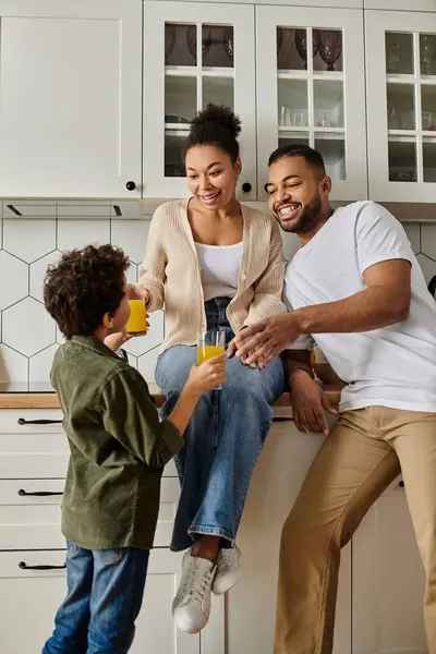 stock image African American man, woman, child laughing on counter.