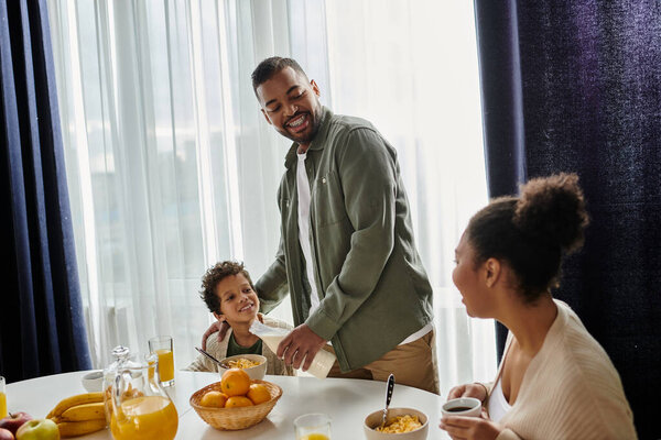 African american family reveling in a meal together, filled with warmth and joy.