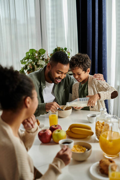 African american family enjoying a meal together at a table.