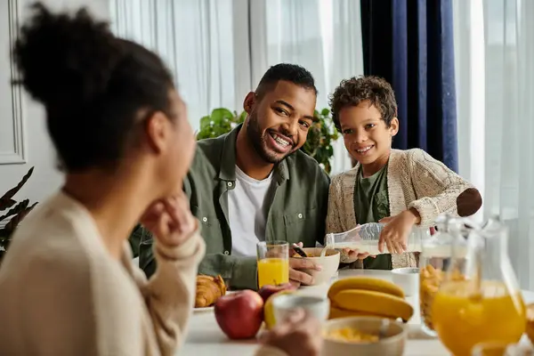 stock image Close-knit African American family sharing food and conversation at the table.