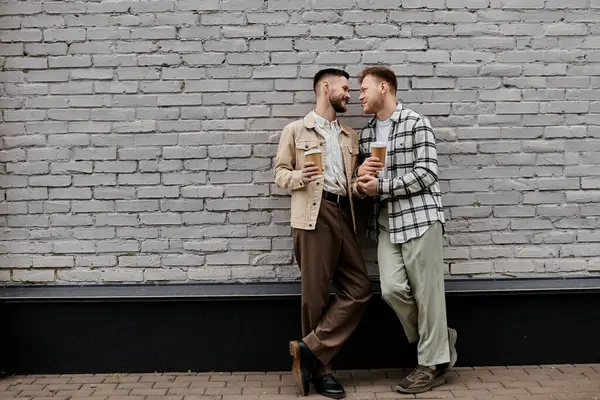 stock image Two men standing together in harmonious unity, showcasing a strong companionship.