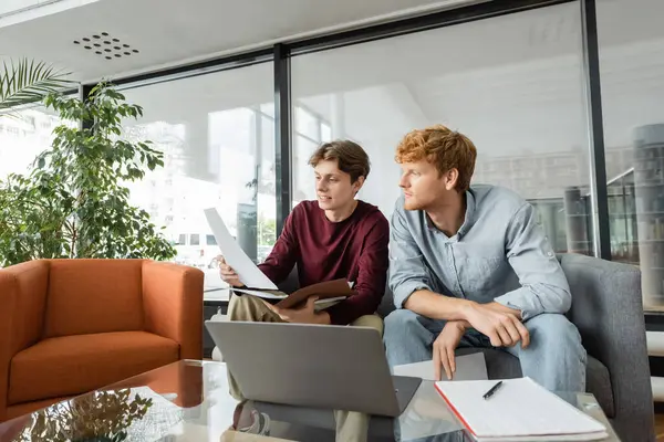 stock image Two men absorbed in laptop content