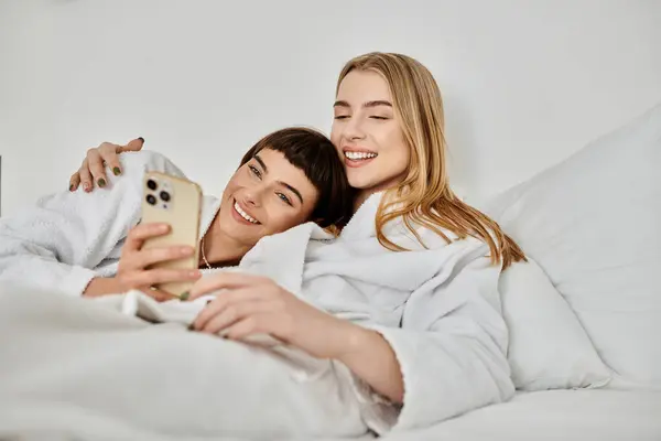 stock image couple in bed, snuggled under a blanket, bathed in soft light, expressing love and tranquility.