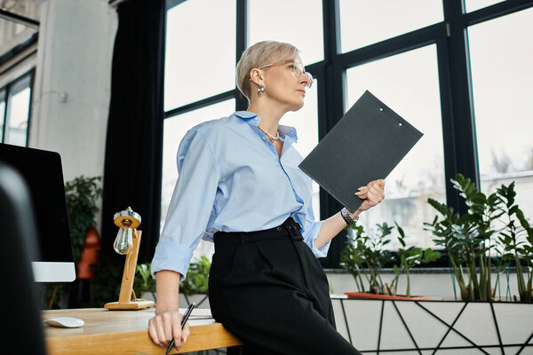 A middle-aged businesswoman with short hair focuses intently while working in the office.