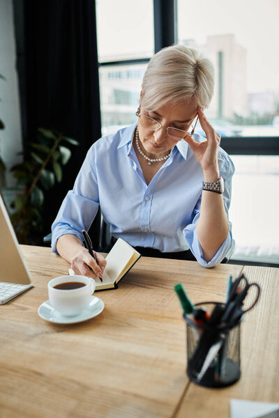 Middle-aged businesswoman with short hair at table in office