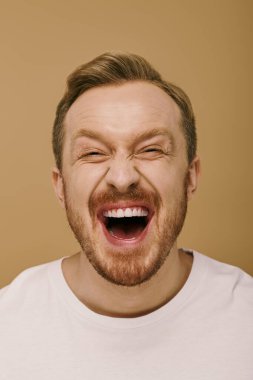 Stylish man with beard posing confidently in white t - shirt. clipart