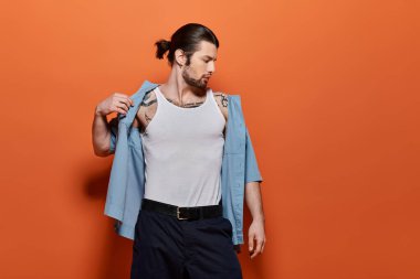 Moda elbiseli yakışıklı beyaz adam kendine güvenir bir şekilde poz veriyor..