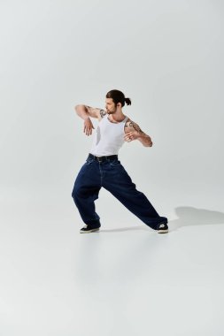 A Caucasian man in trendy attire gracefully dances in a white shirt. clipart