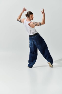 A lively Caucasian man showcases his moves in a white tank top. clipart