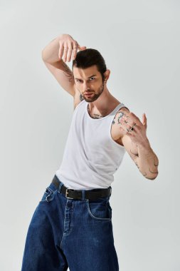 Beyaz adam moda kıyafetleriyle dans figürleri sergiliyor..