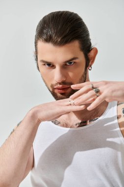 A handsome caucasian man showcases his intricate arm tattoo. clipart