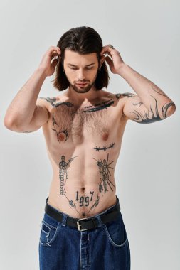 Shirtless man showcasing vibrant chest tattoos. clipart