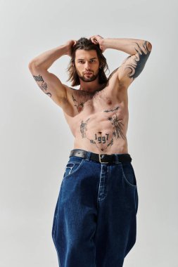 Handsome Caucasian man proudly displays chest tattoos. clipart