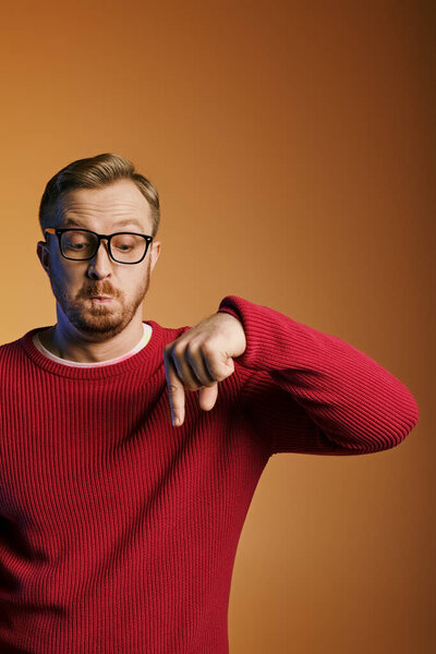 Stylish man in red sweater gestures energetically.