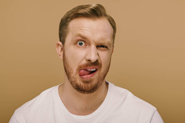 Handsome man posing actively with a surprised expression on his face.