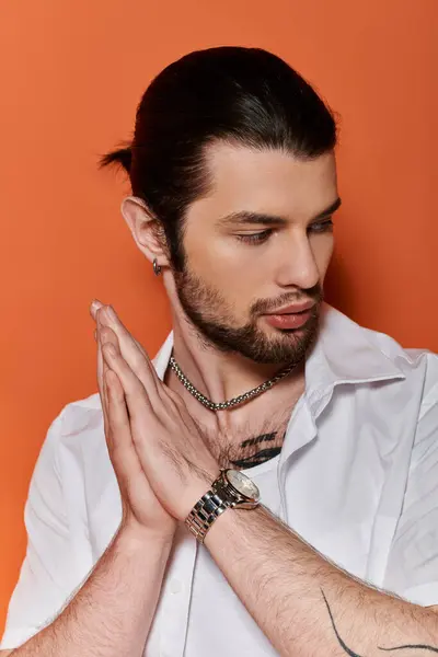 stock image Handsome man in white shirt, holding hands together.