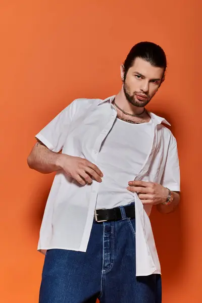 stock image Handsome Caucasian man dressed in trendy white shirt and blue jeans.