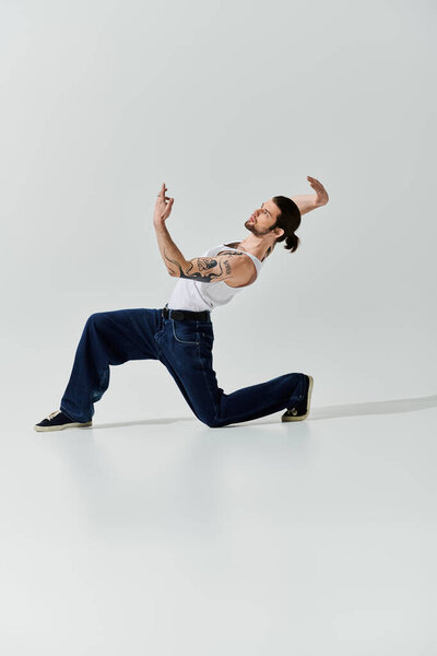 A stylish Caucasian man mesmerizes with a daring trick in a white shirt.