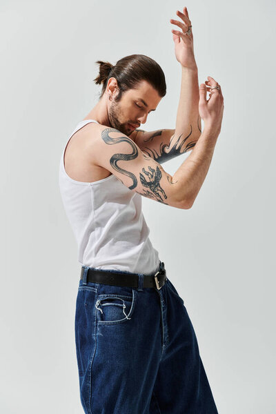 Стильный кавказский мужчина в майке танка танцует с бодростью.