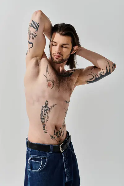 stock image Muscular man displays intricate chest tattoos.