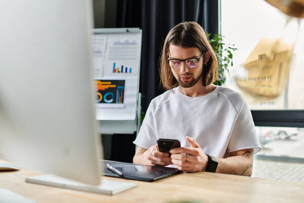 Caucasian businessman at desk, absorbed in phone.