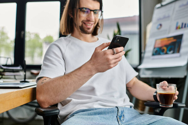 A man, businessman, using a cell phone while seated in a chair.