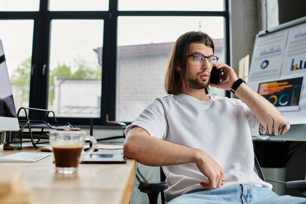 Caucasian businessman engrossed in phone conversation at desk.